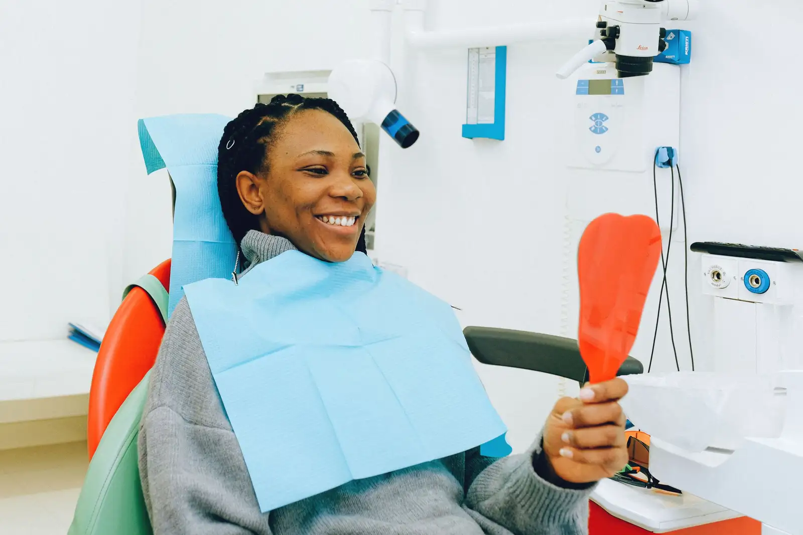 A patient checking their smile in a mirror